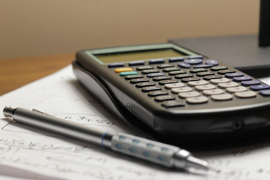 Payroll reconciliation with calculator, financial documents and spreadsheet
