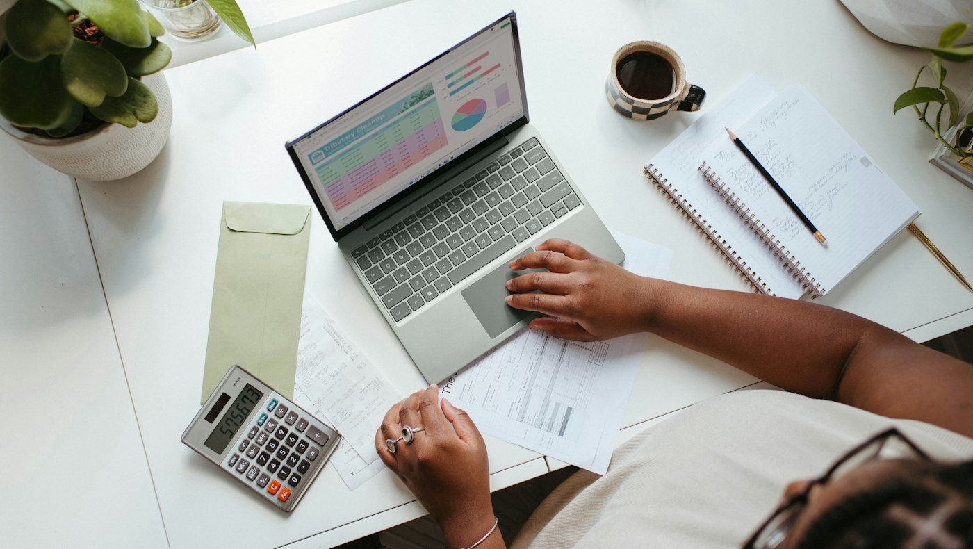 Professional reviewing documents with a laptop for GST invoice and transport compliance