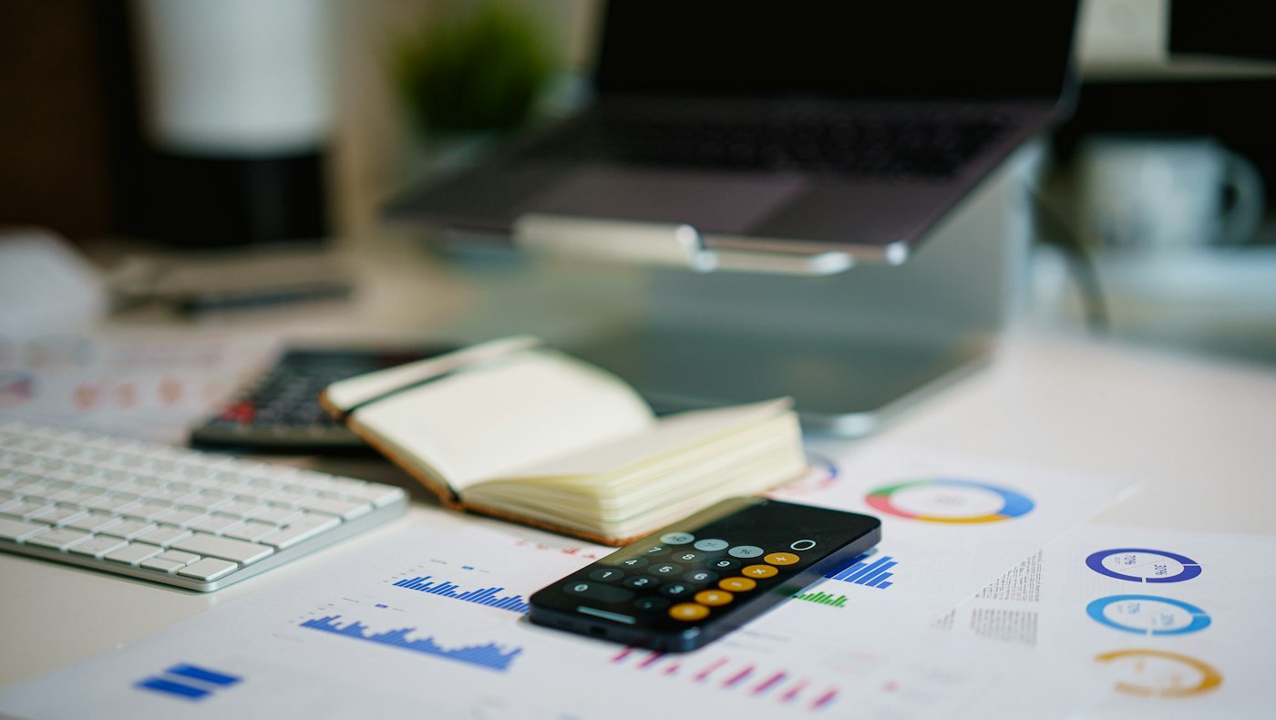 Financial report and calculator representing GSTR-1 filing and GST reconciliation