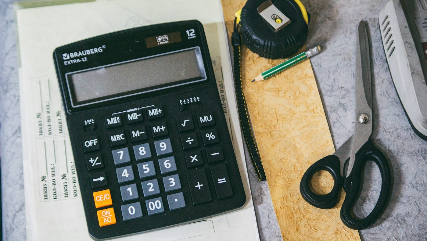Calculator and office documents representing GSTR-2B purchase register and ITC reconciliation