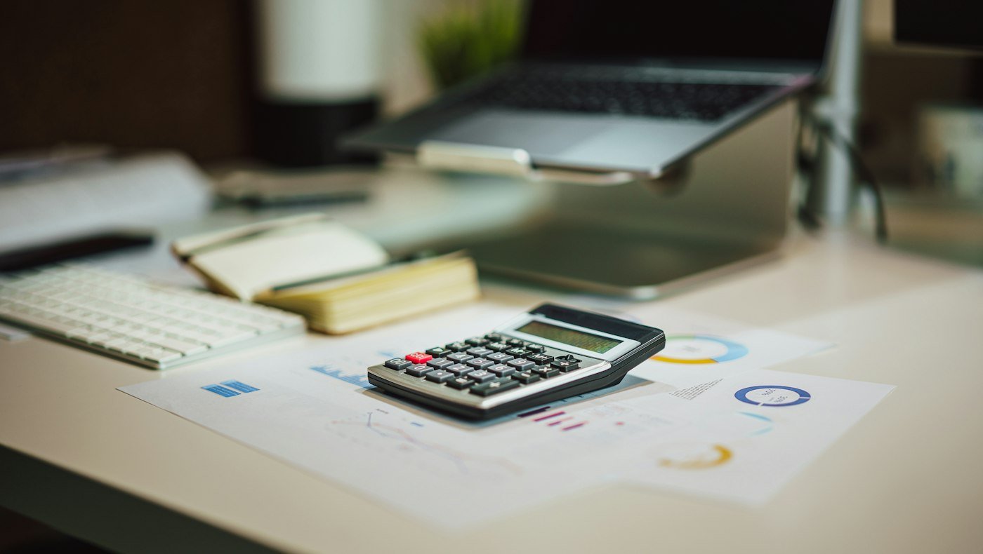 Calculator and accounting documents representing GSTR-3B tax liability and ITC review